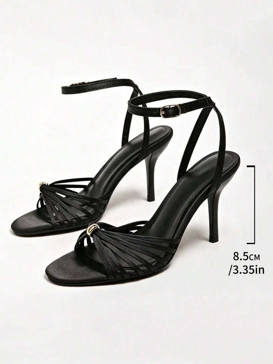 Women's open toe stiletto high heel sandals featuring metallic knot decor and an adjustable ankle buckle strap.