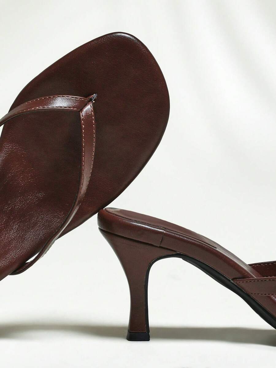 Women's minimalist black PU leather thong heel sandals featuring kitten heels and rhinestone accents