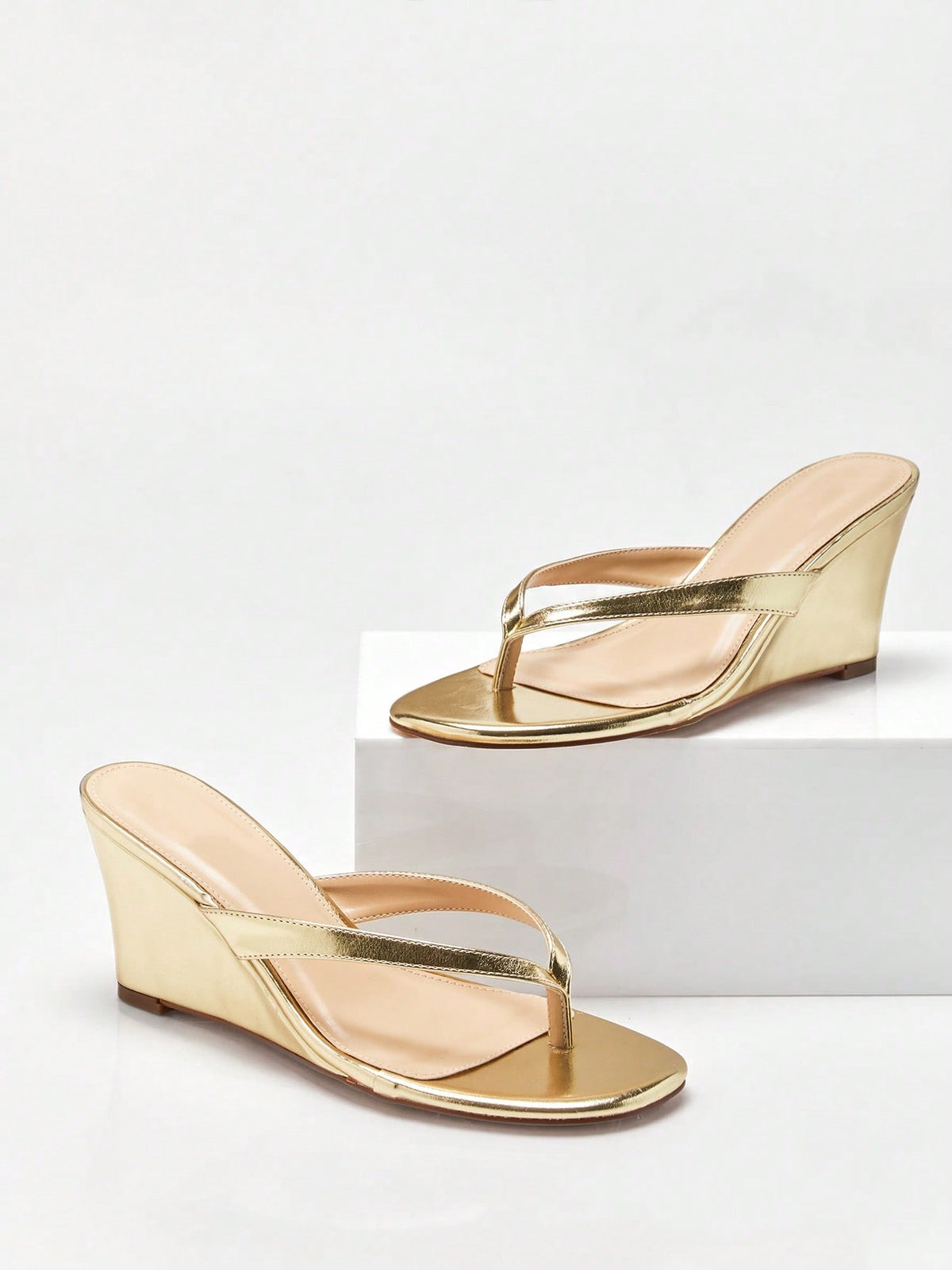 Women's faux suede thong wedge sandals featuring rope detail and high platform wedge sole