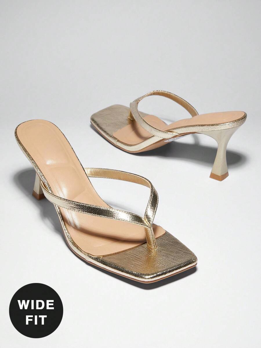 Women's square toe kitten heel thong heeled sandals featuring an asymmetrical strap design and mid heel