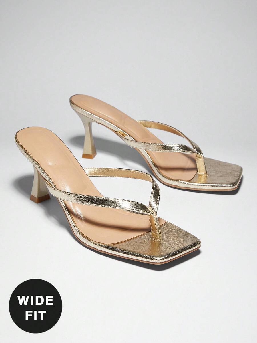 Women's square toe kitten heel thong heeled sandals featuring an asymmetrical strap design and mid heel