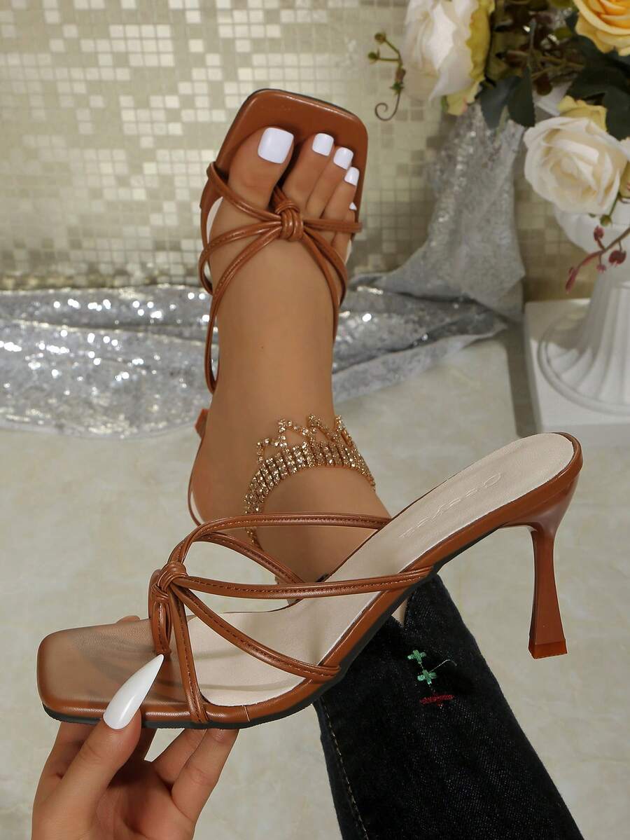 Elegant women's solid color clip toe high-heeled sandals with twist strap detail and slingback kitten heel design.