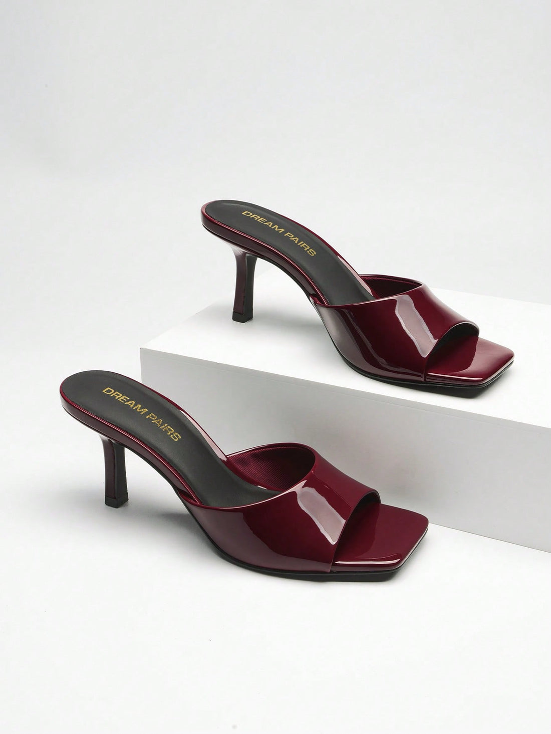Pair of women's open square toe kitten heel mule sandals in white PU leather with slip-on styling.