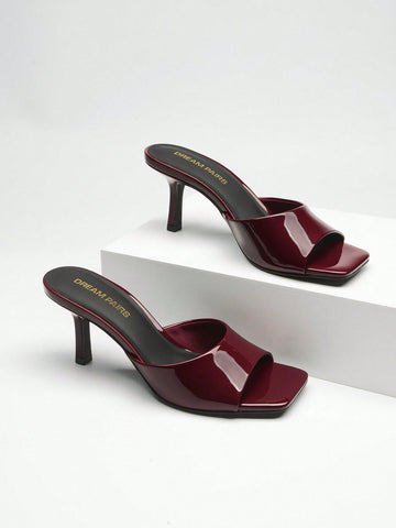 Pair of women's open square toe kitten heel mule sandals in white PU leather with slip-on styling.
