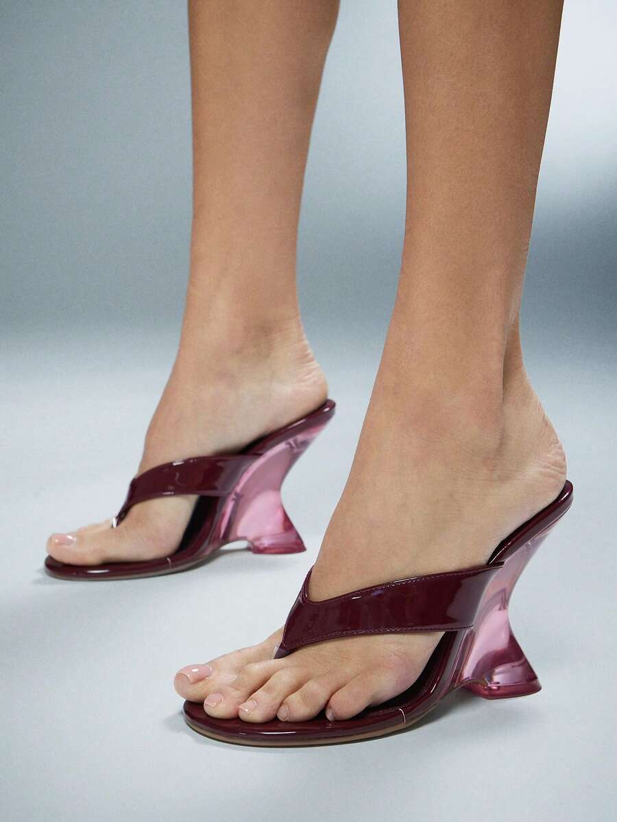 Women's slip-on thong strap wedge sandals featuring a high wedge heel and smooth PU leather upper.