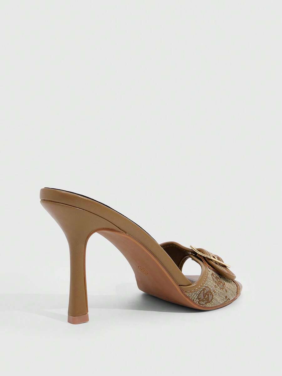 Women's brown leopard print high heel mule sandals with gold-tone buckle and grommet eyelet accents.