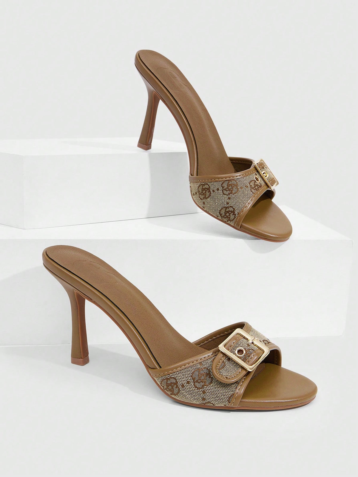 Women's brown leopard print high heel mule sandals with gold-tone buckle and grommet eyelet accents.