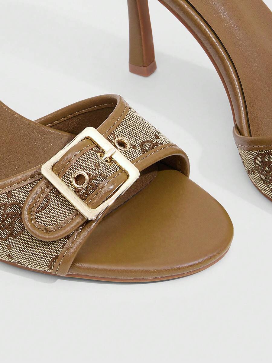 Women's brown leopard print high heel mule sandals with gold-tone buckle and grommet eyelet accents.