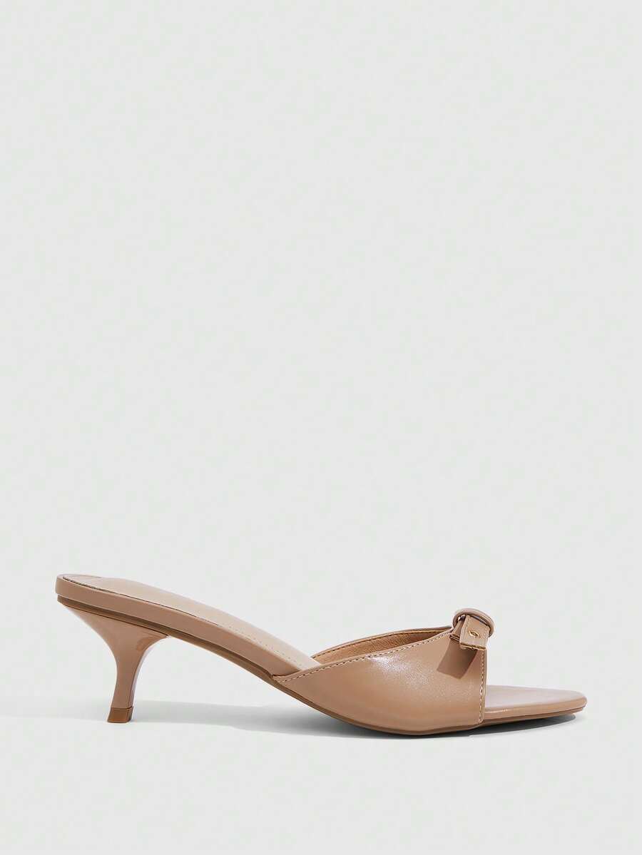 Women's light gold kitten heel slingback sandals featuring an open toe and round buckle strap.