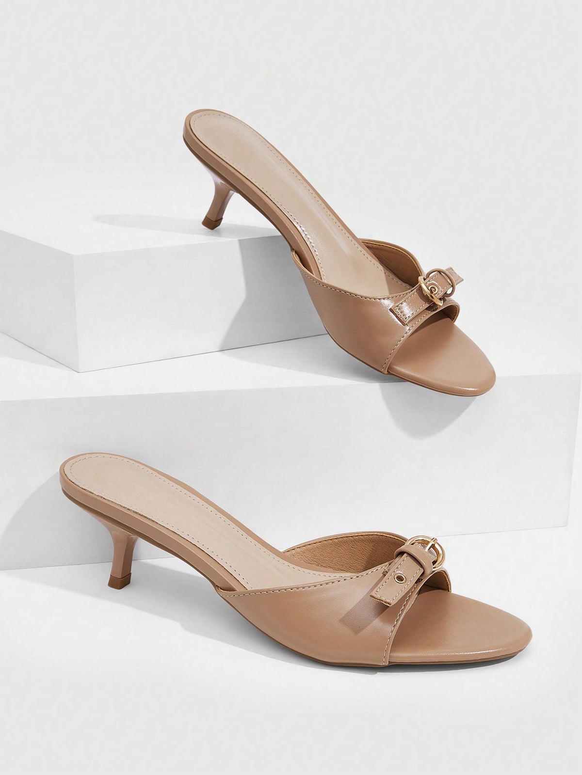 Women's light gold kitten heel slingback sandals featuring an open toe and round buckle strap.
