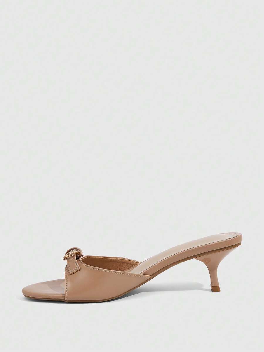 Women's light gold kitten heel slingback sandals featuring an open toe and round buckle strap.