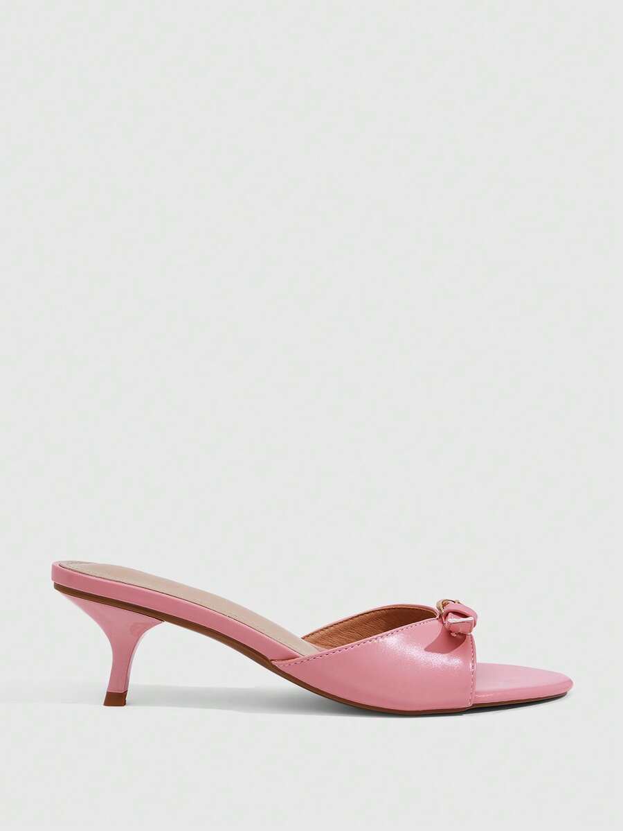 Women's light gold kitten heel slingback sandals featuring an open toe and round buckle strap.