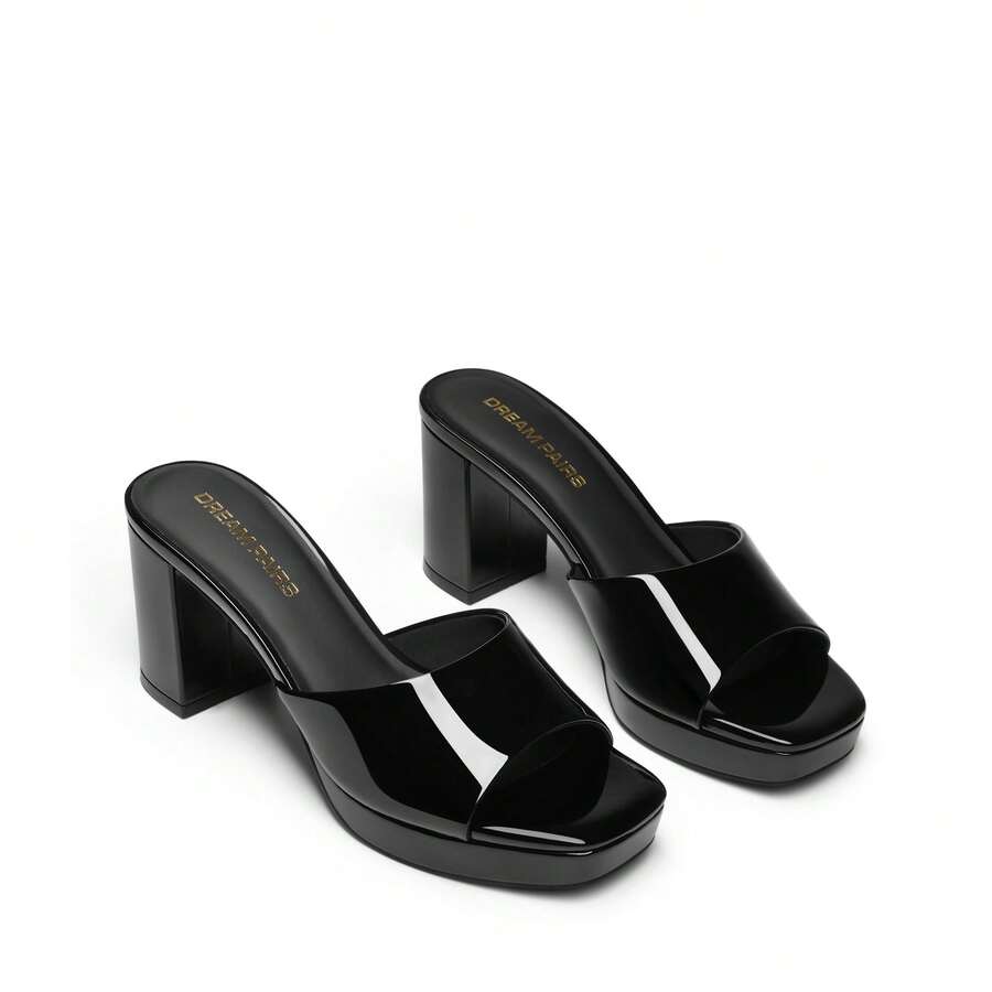 Women's minimalist open toe mule sandals featuring a chunky low heel, wide single strap, and slip-on design.