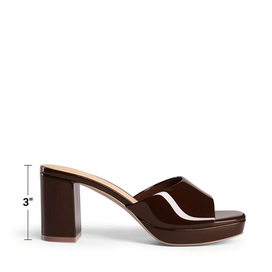 Women's minimalist open toe mule sandals featuring a chunky low heel, wide single strap, and slip-on design.