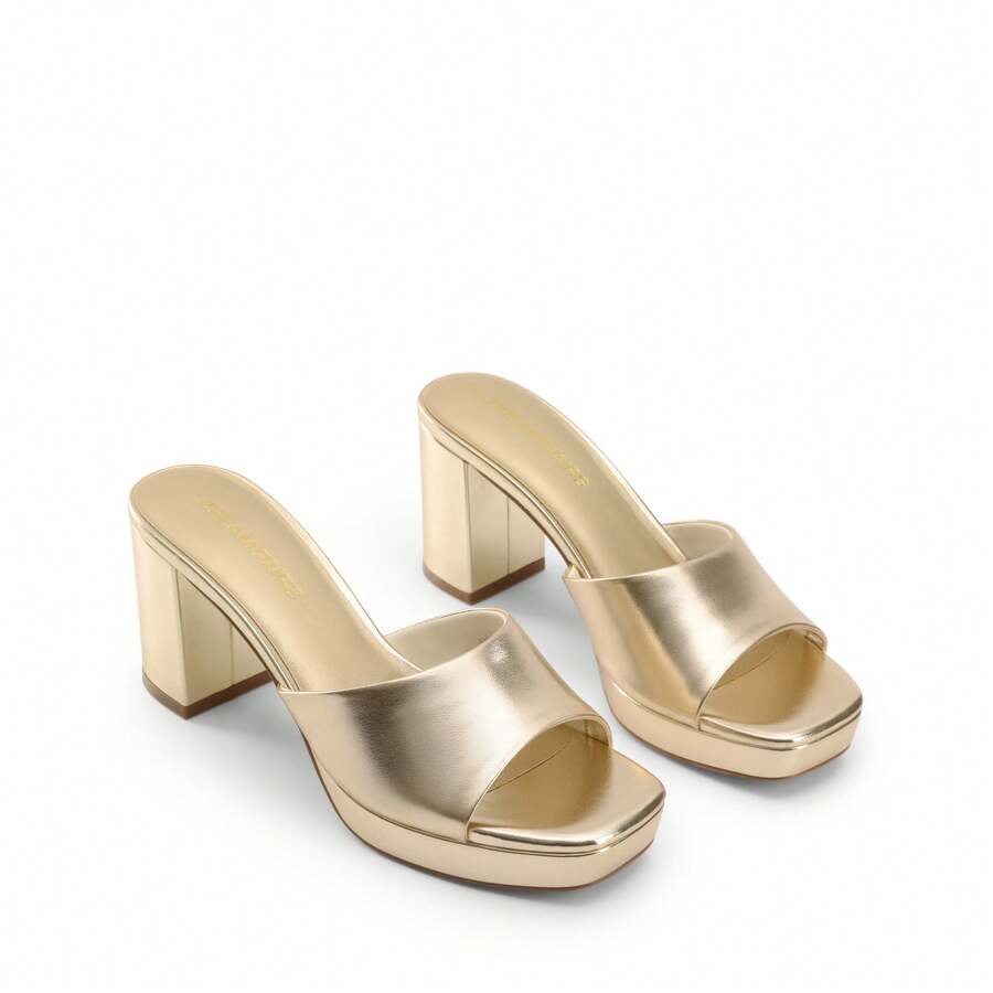 Women's minimalist open toe mule sandals featuring a chunky low heel, wide single strap, and slip-on design.