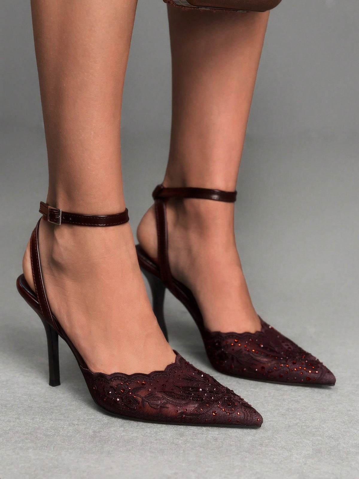 Women's stiletto high heel shoes featuring an elegant buckle detail and ankle strap slingback design.