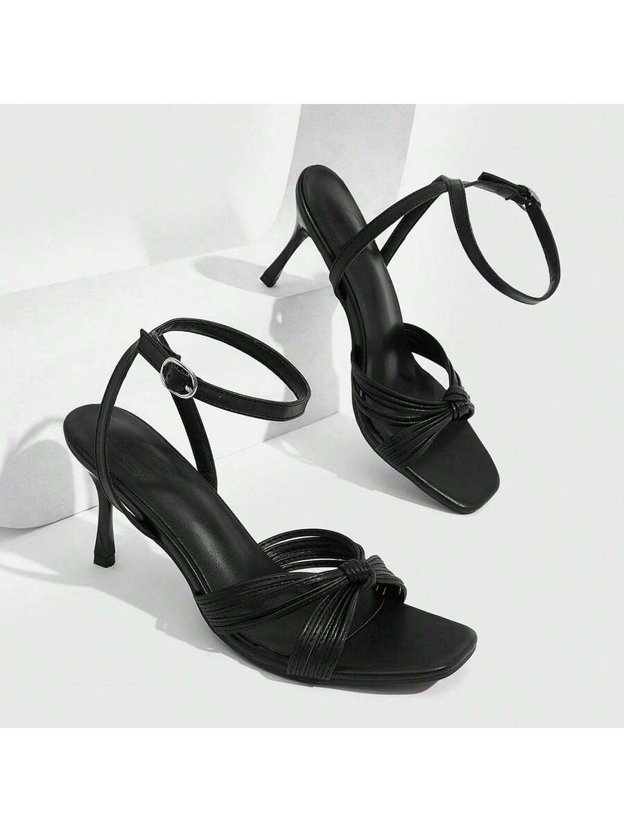 Women's high heel sandals featuring pleated strap detailing, an adjustable ankle strap with buckle closure, round open toe, and slim stiletto heel.