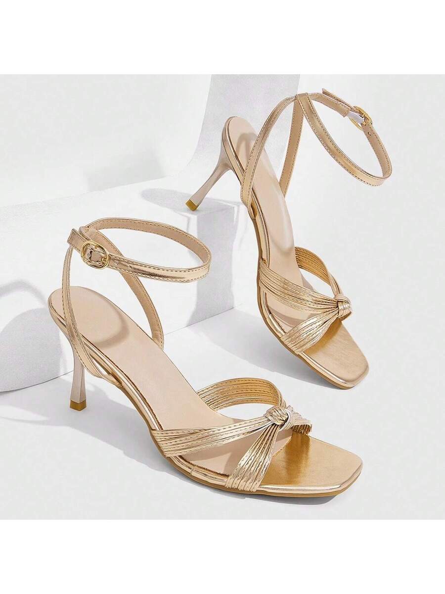 Women's high heel sandals featuring pleated strap detailing, an adjustable ankle strap with buckle closure, round open toe, and slim stiletto heel.