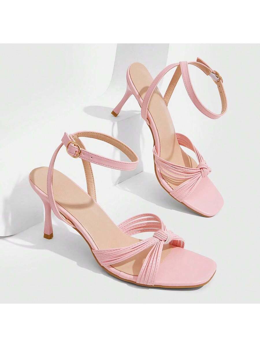 Women's high heel sandals featuring pleated strap detailing, an adjustable ankle strap with buckle closure, round open toe, and slim stiletto heel.