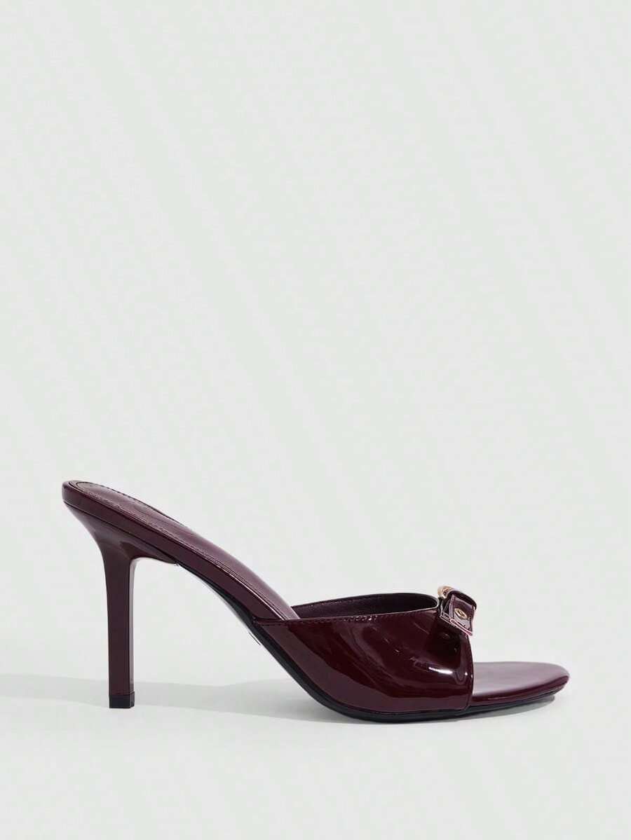 Elegant burgundy high heel slingback sandals with an open toe and round buckle strap.
