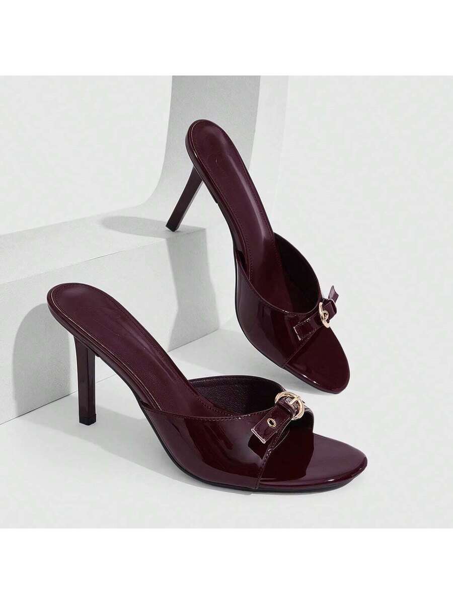 Elegant burgundy high heel slingback sandals with an open toe and round buckle strap.