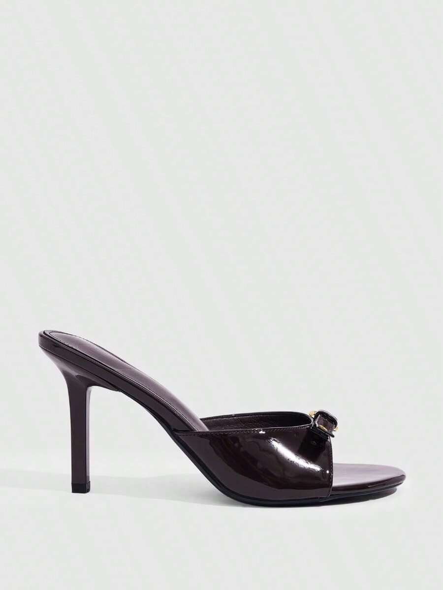 Women's light gold kitten heel slingback sandals featuring an open toe and round buckle strap.
