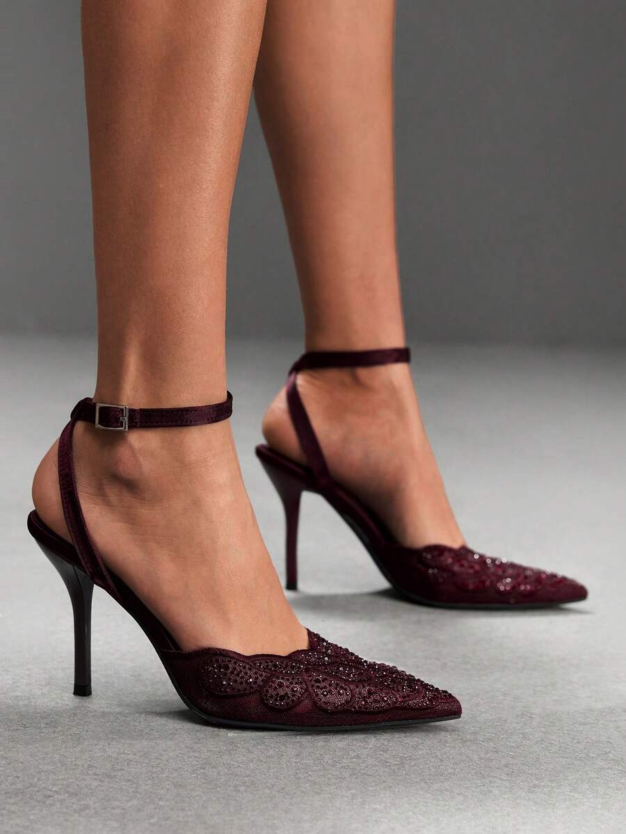 Women's stiletto high heel shoes featuring an elegant buckle detail and ankle strap slingback design.