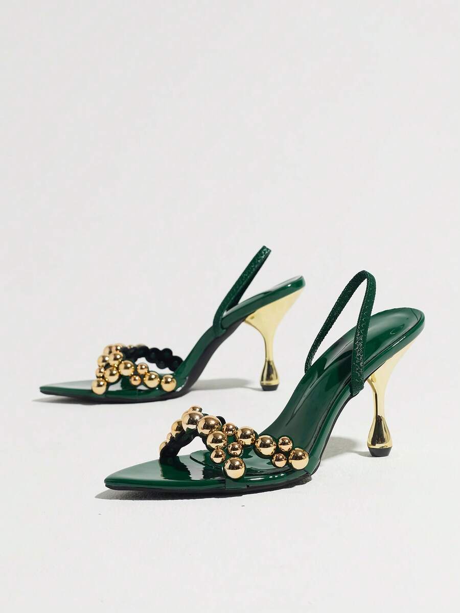 Pointed toe party high heels in gold featuring wavy lace trim, a stiletto heel, and back tie slingback straps.