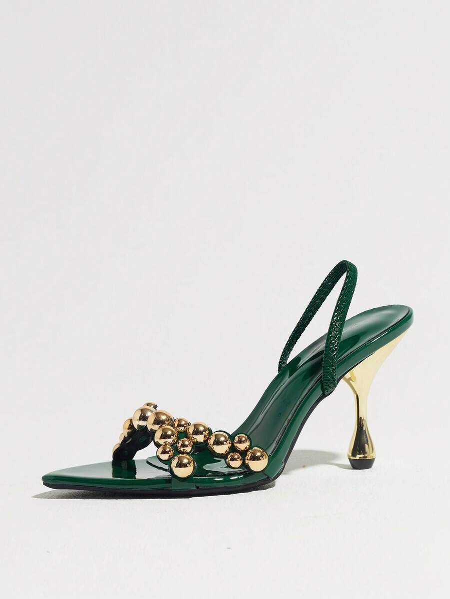 Pointed toe party high heels in gold featuring wavy lace trim, a stiletto heel, and back tie slingback straps.