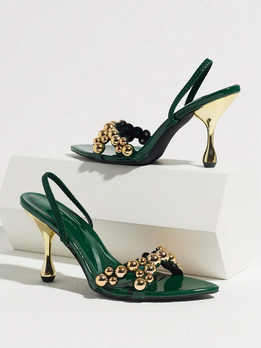 Pointed toe party high heels in gold featuring wavy lace trim, a stiletto heel, and back tie slingback straps.