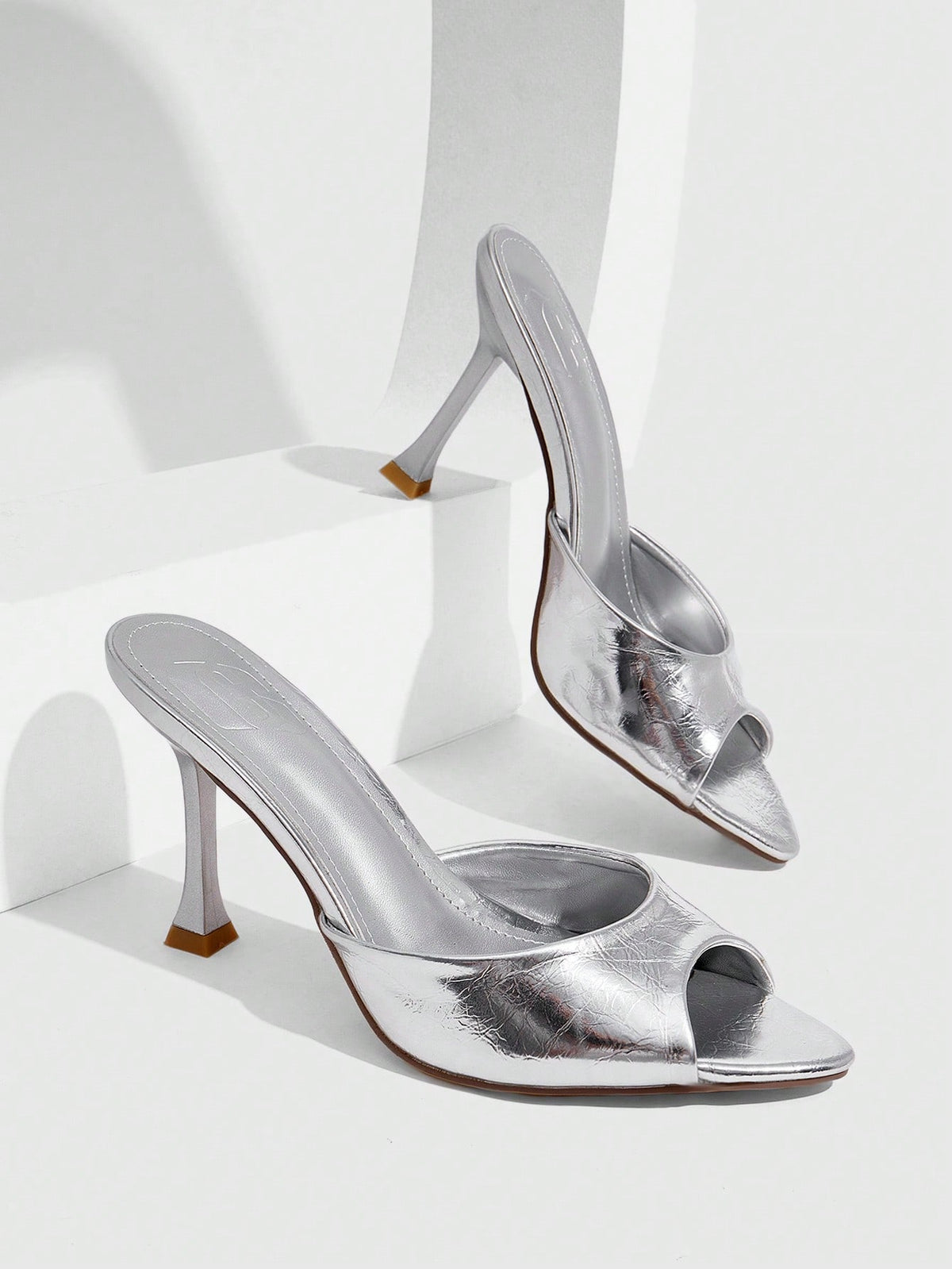 Women's sleek high heel slingback sandals with PU leather finish and stylish pyramid heel.