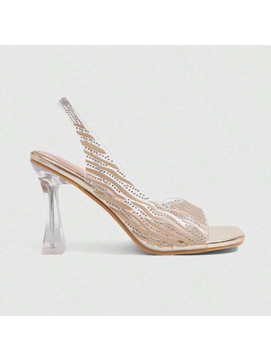 Women's square toe heeled sandals with clear straps, sparkling rhinestone embellishments, and a high pyramid heel.