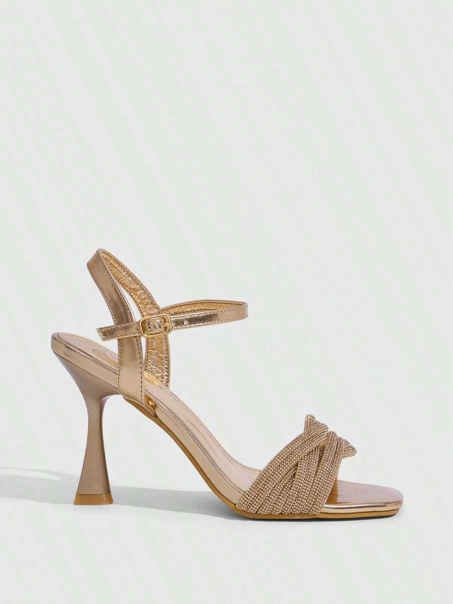 Women's gold open square toe high-heeled sandals featuring a stylish twist strap and stiletto heel.