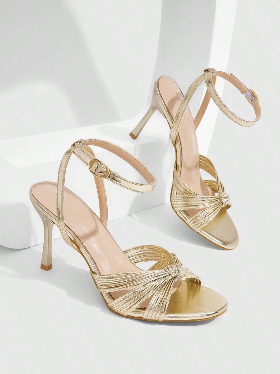Women's high heel sandals featuring pleated strap detailing, an adjustable ankle strap with buckle closure, round open toe, and slim stiletto heel.