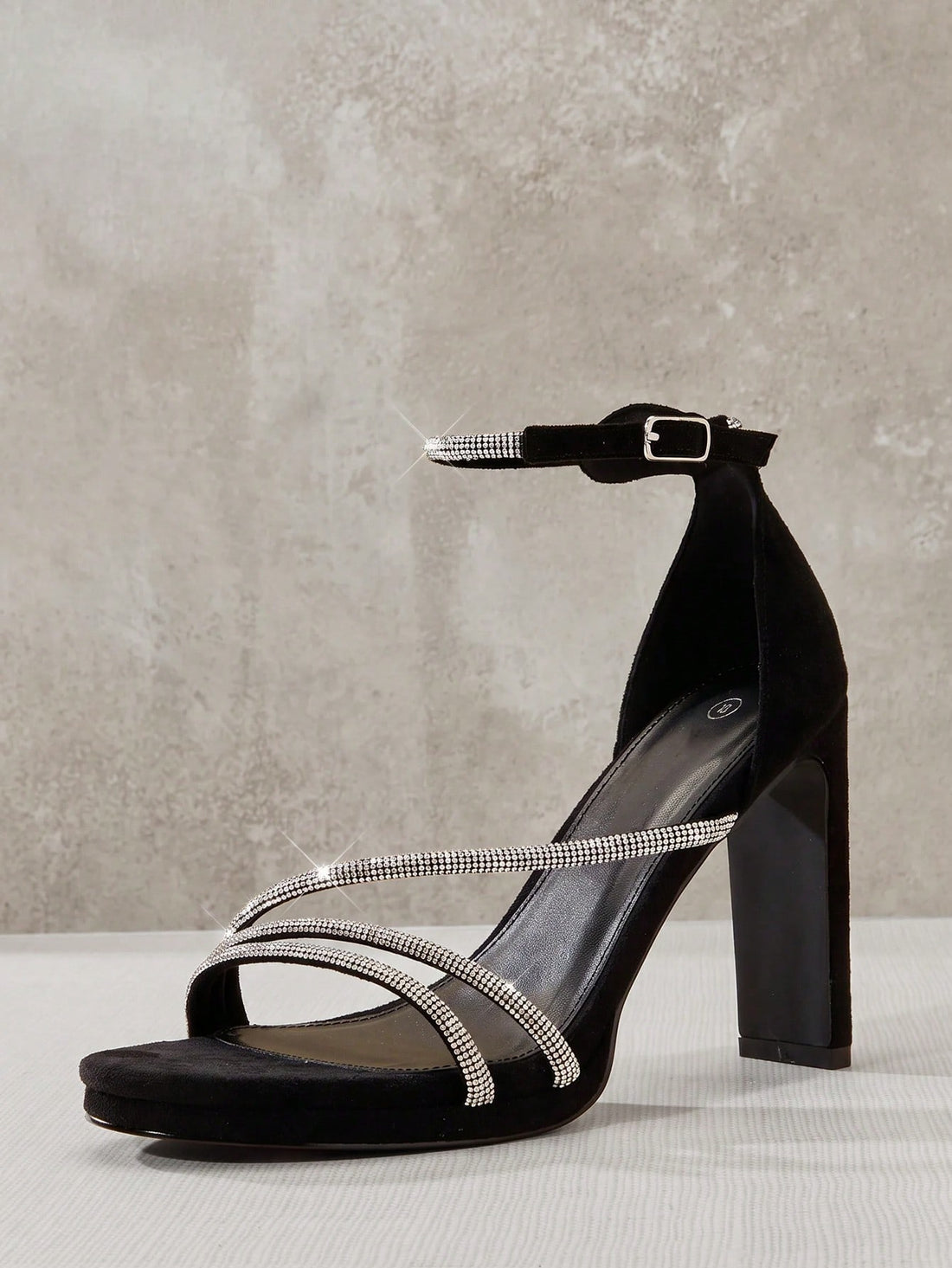 Open square toe high heel sandals with sparkling rhinestone straps, an adjustable ankle buckle closure, and a sleek stiletto heel.