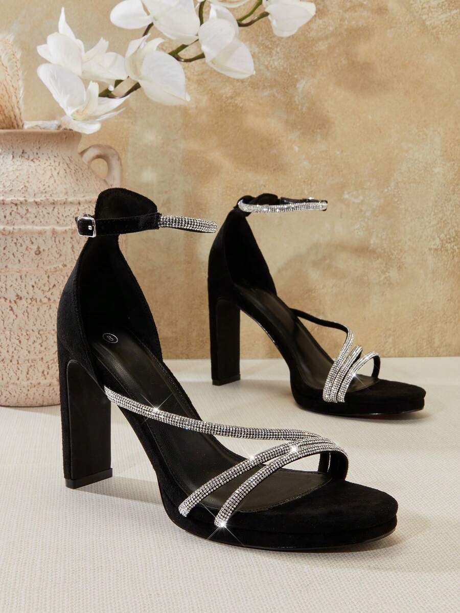 Open square toe high heel sandals with sparkling rhinestone straps, an adjustable ankle buckle closure, and a sleek stiletto heel.