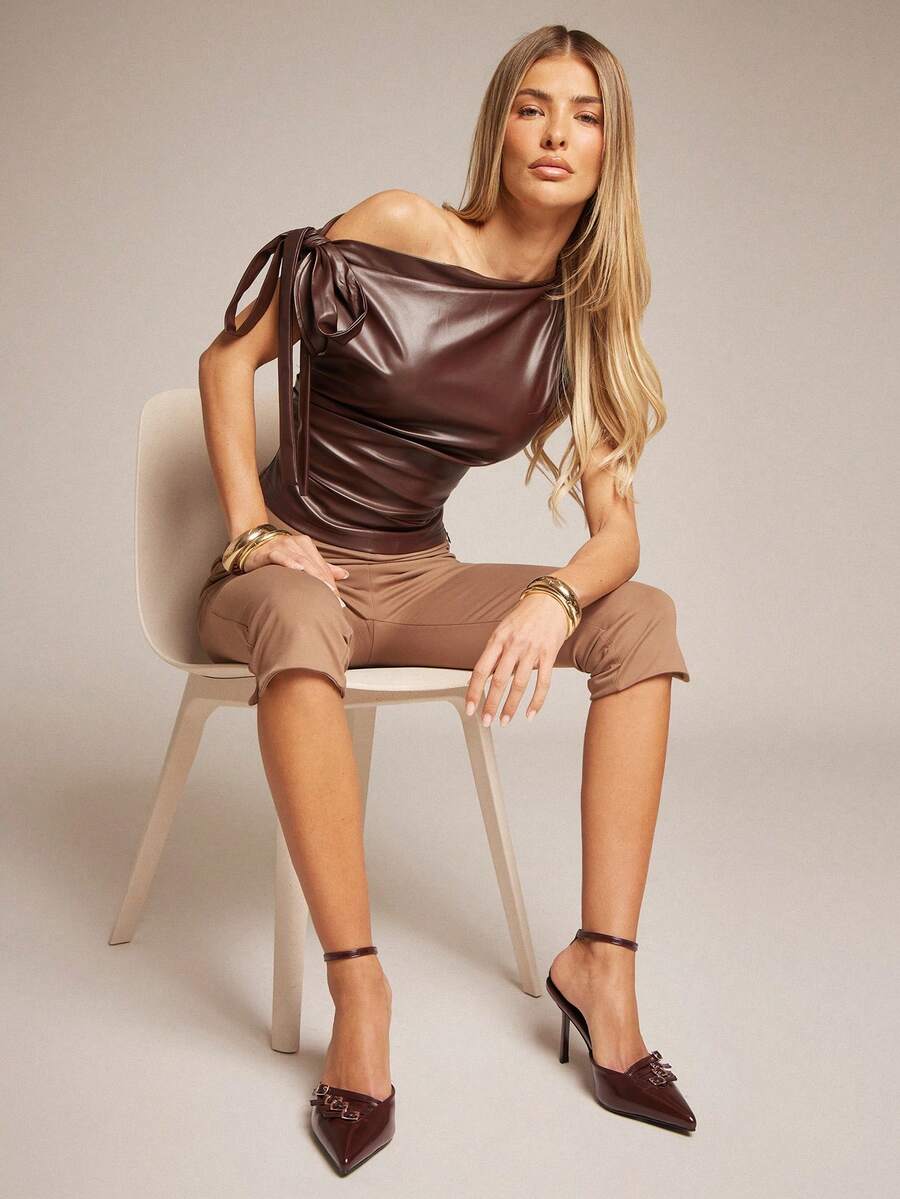 Women's pointed toe stiletto heel slingback pumps in chocolate brown with double metal buckle strap details.