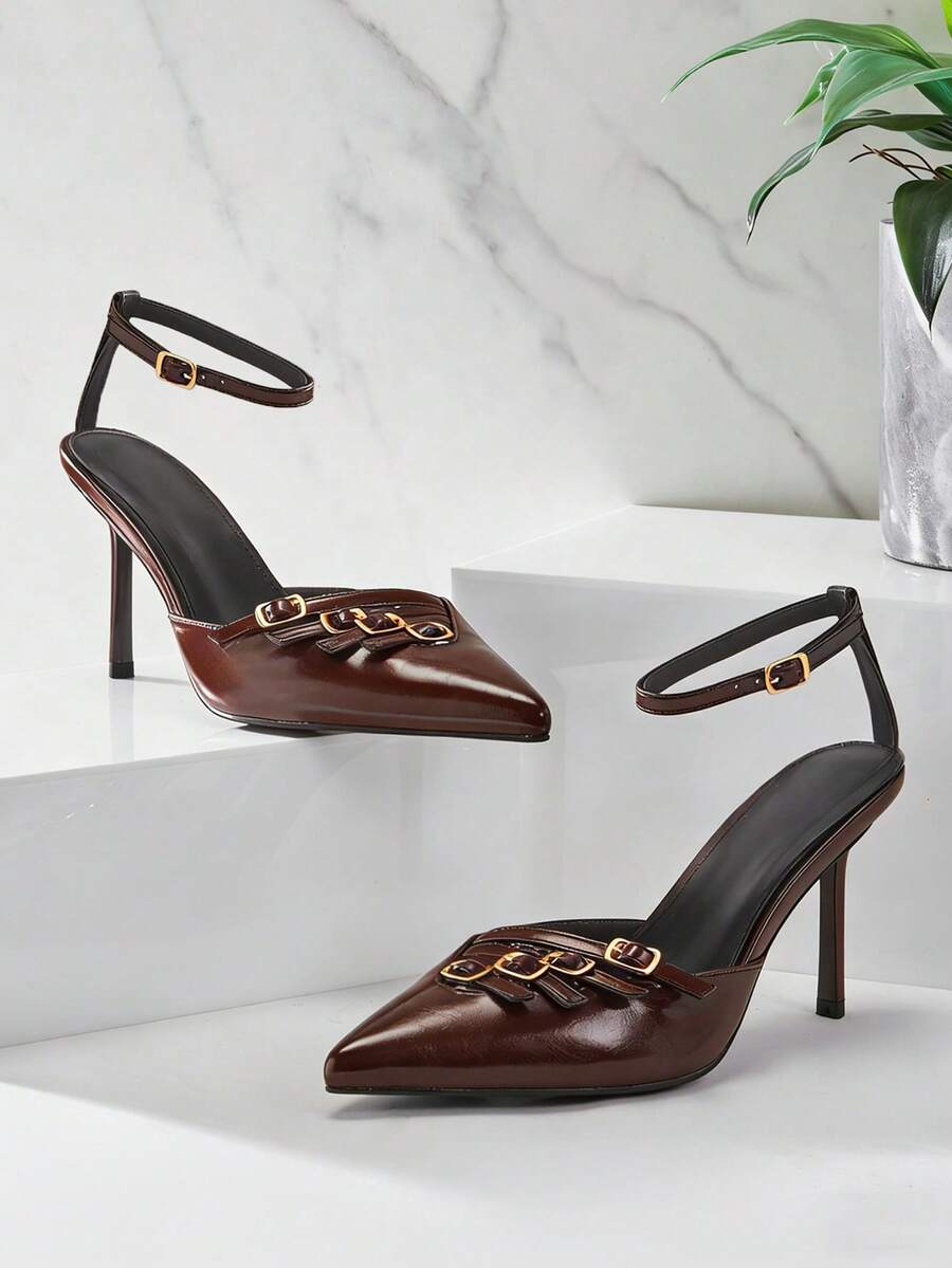 Women's pointed toe stiletto heel slingback pumps in chocolate brown with double metal buckle strap details.