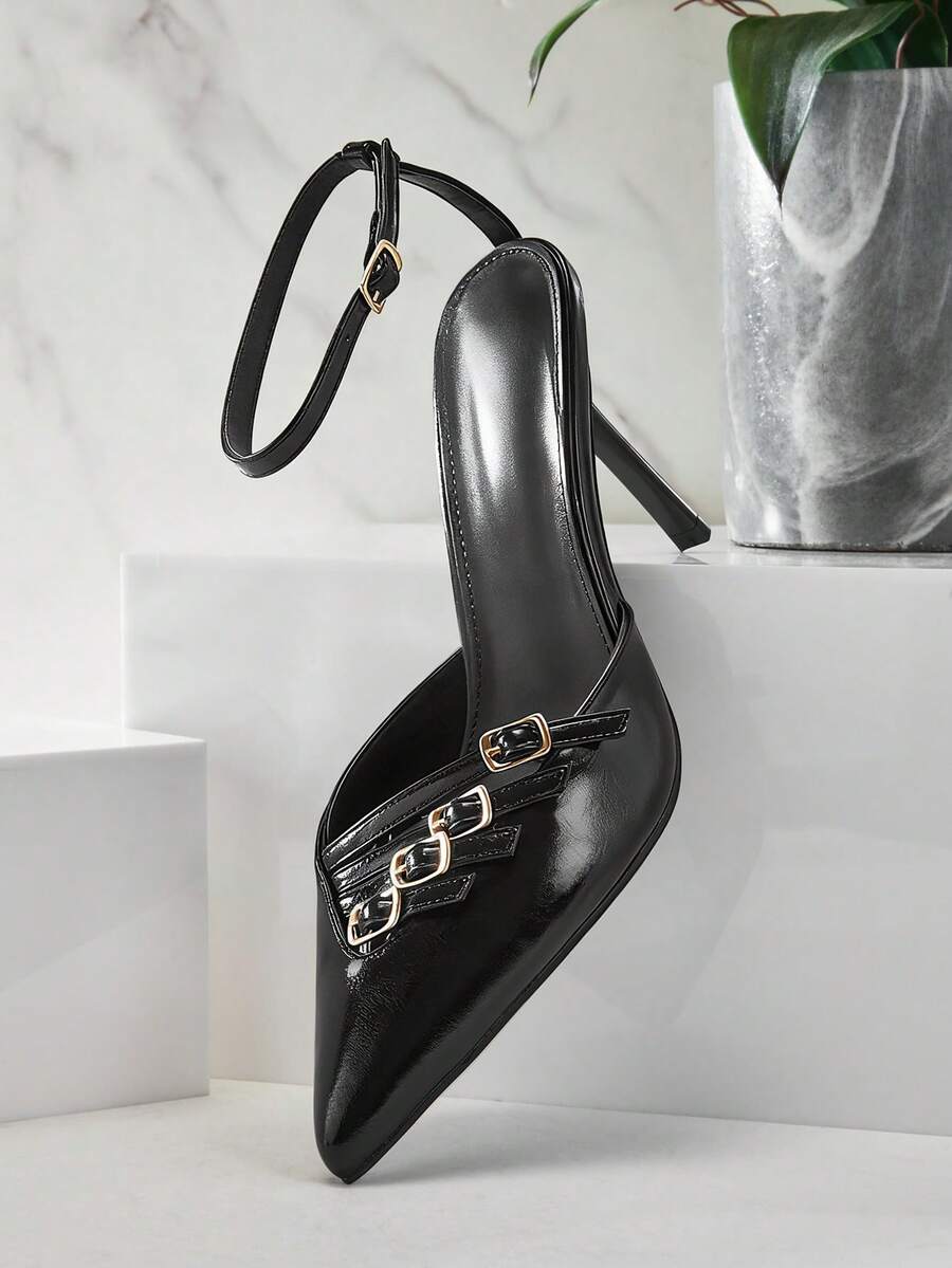 Women's pointed toe stiletto heel slingback pumps in chocolate brown with double metal buckle strap details.