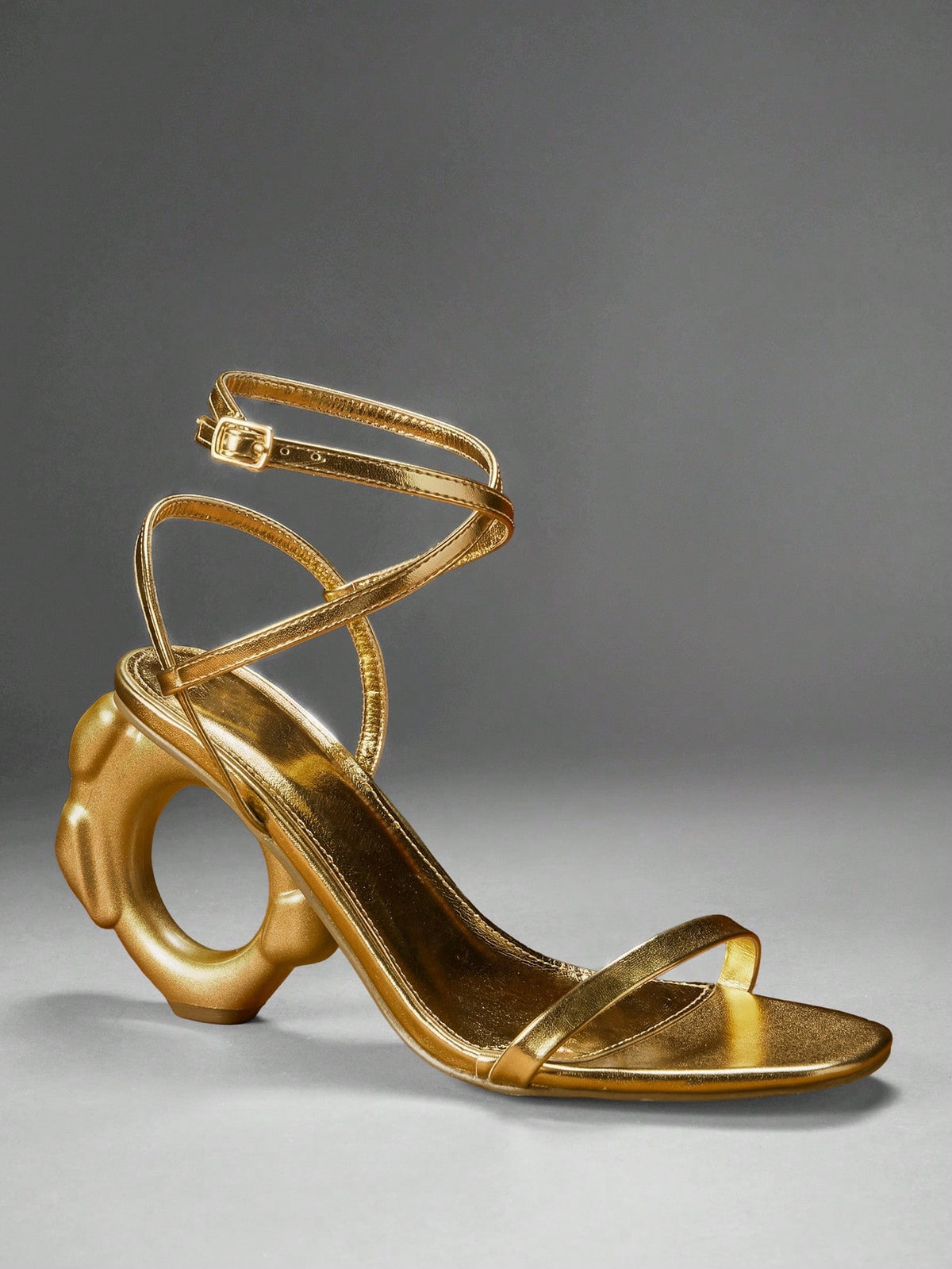 Women's slip-on heeled sandals in gold PU leather featuring a pointed toe and sculptural ball-shaped mid heel.
