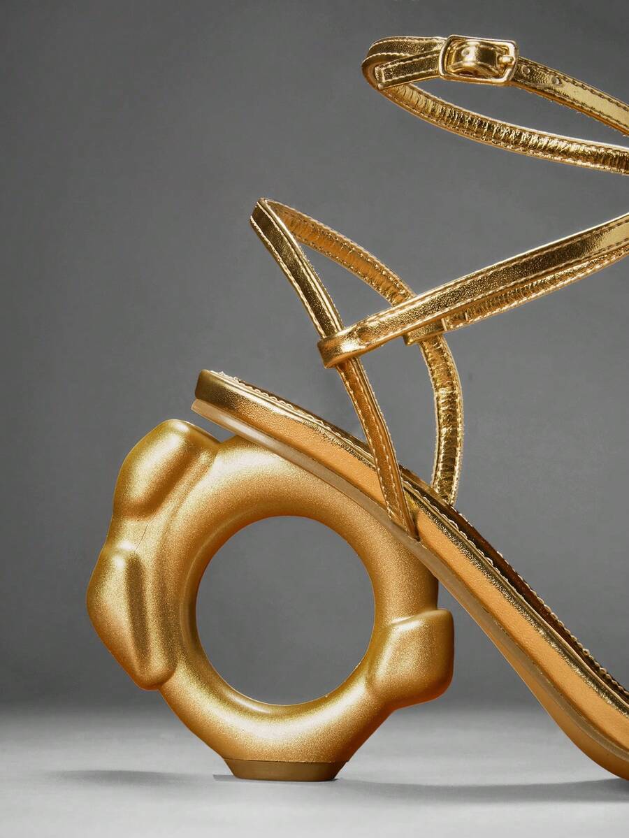 Women's slip-on heeled sandals in gold PU leather featuring a pointed toe and sculptural ball-shaped mid heel.