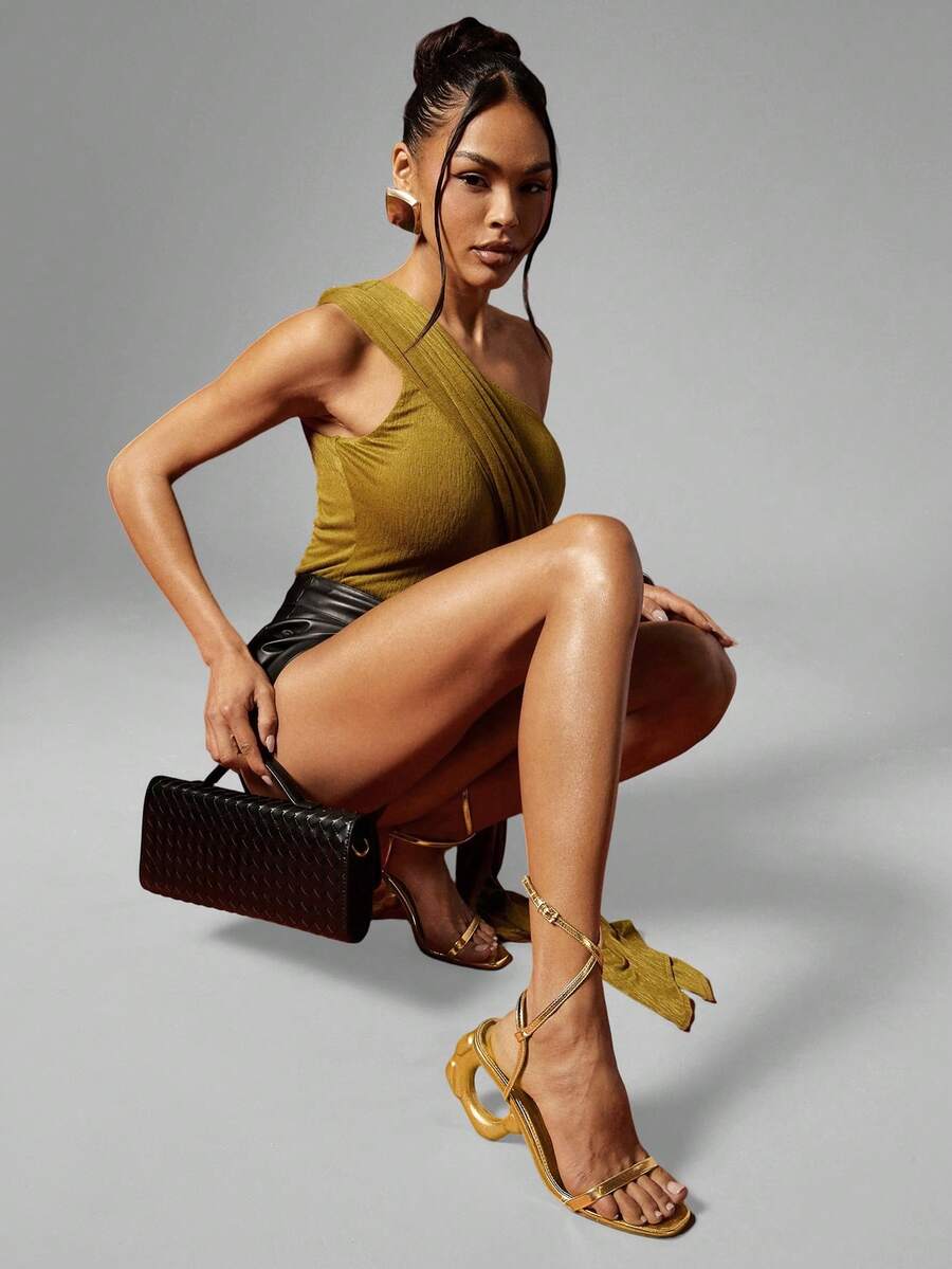 Women's slip-on heeled sandals in gold PU leather featuring a pointed toe and sculptural ball-shaped mid heel.