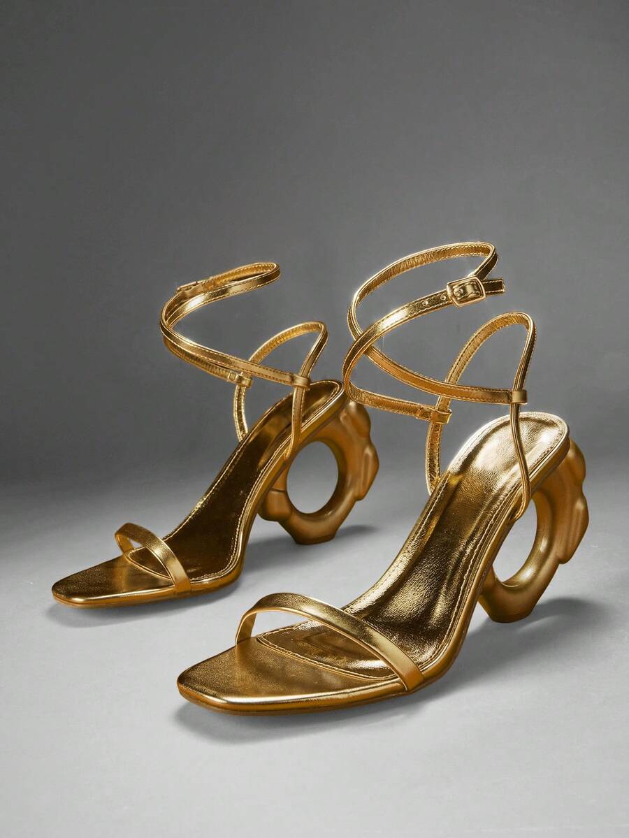 Women's slip-on heeled sandals in gold PU leather featuring a pointed toe and sculptural ball-shaped mid heel.