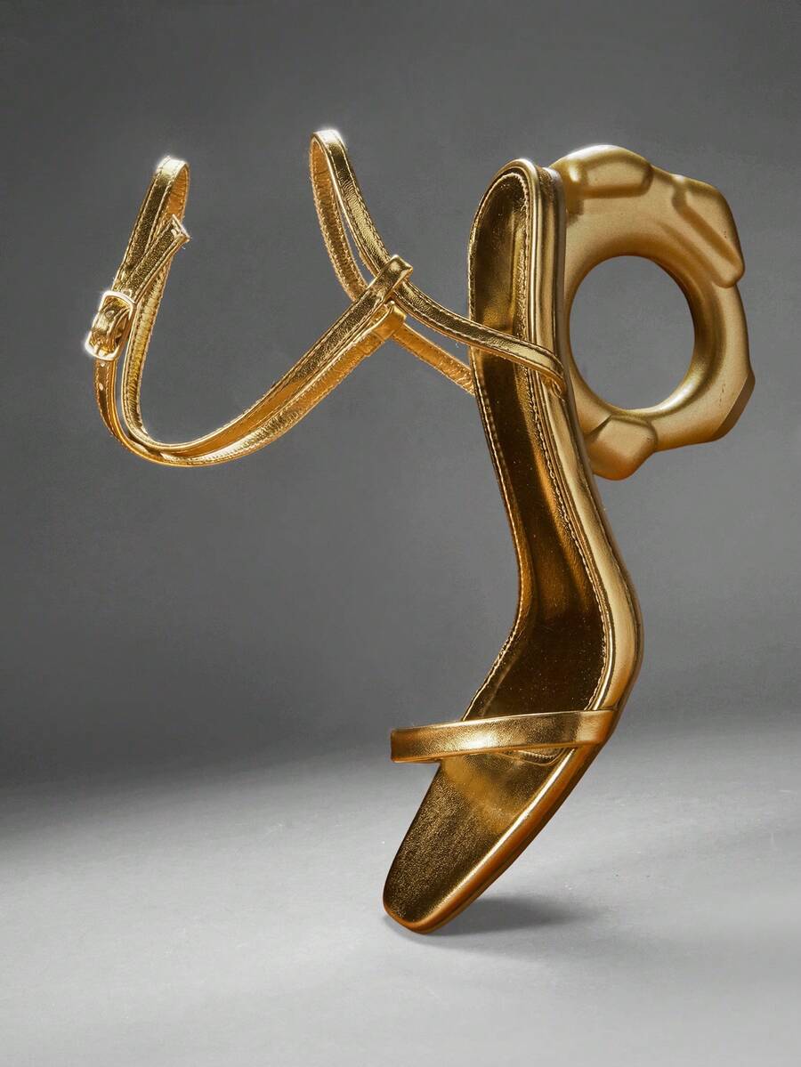 Women's slip-on heeled sandals in gold PU leather featuring a pointed toe and sculptural ball-shaped mid heel.
