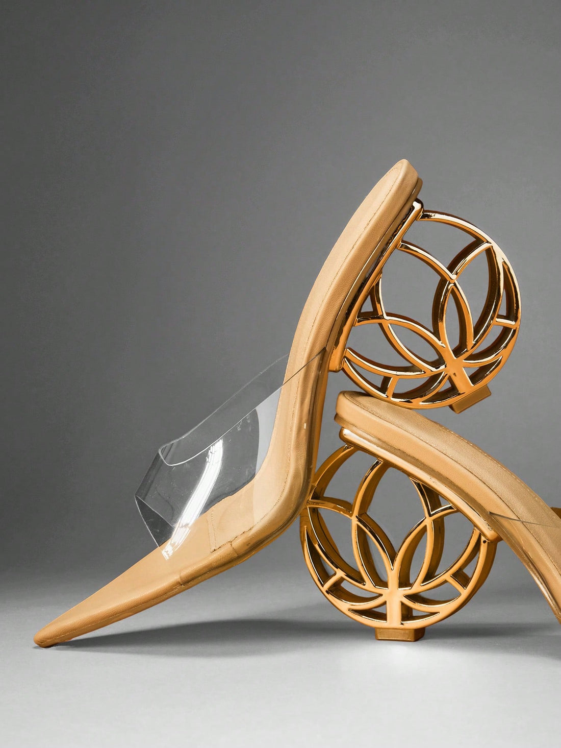Women's slip-on heeled sandals in gold PU leather featuring a pointed toe and sculptural ball-shaped mid heel.