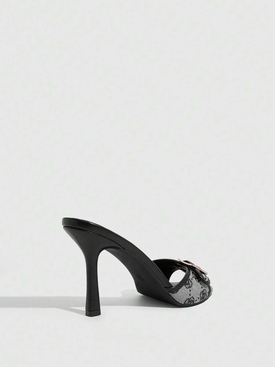 Women's brown leopard print high heel mule sandals with gold-tone buckle and grommet eyelet accents.