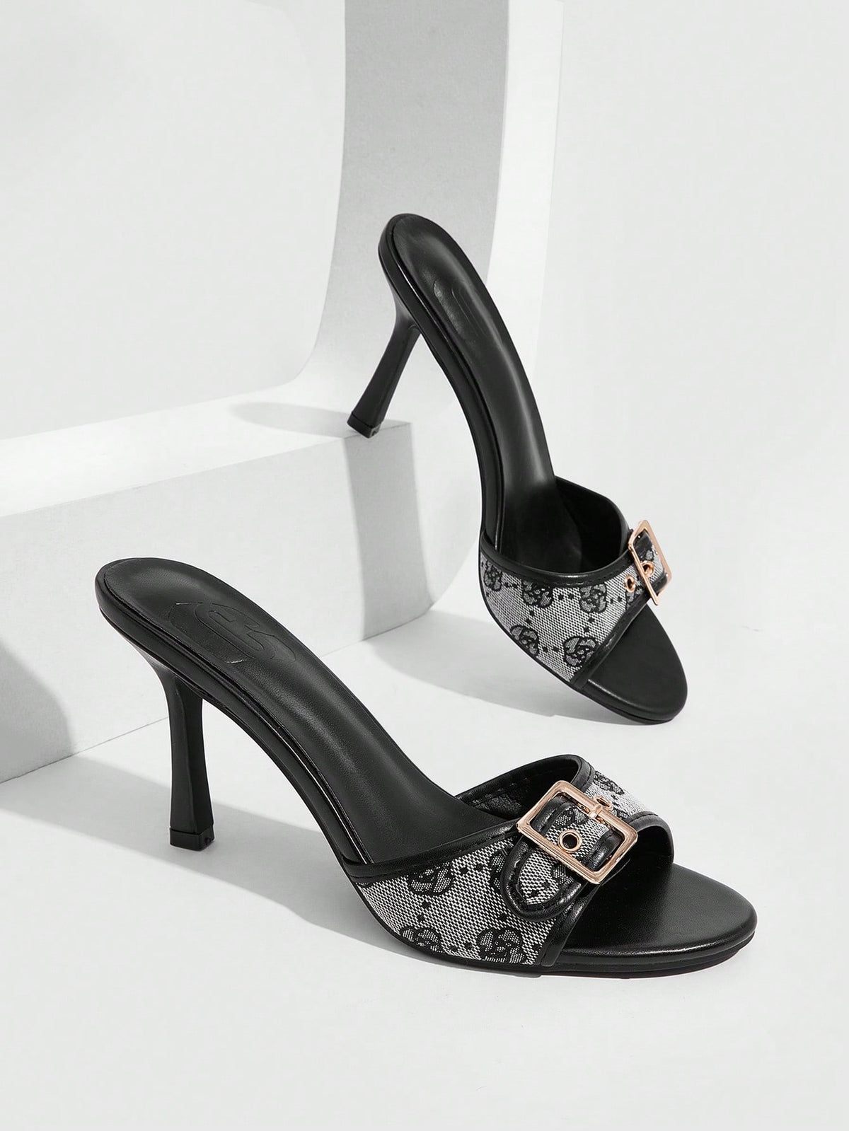 Women's brown leopard print high heel mule sandals with gold-tone buckle and grommet eyelet accents.