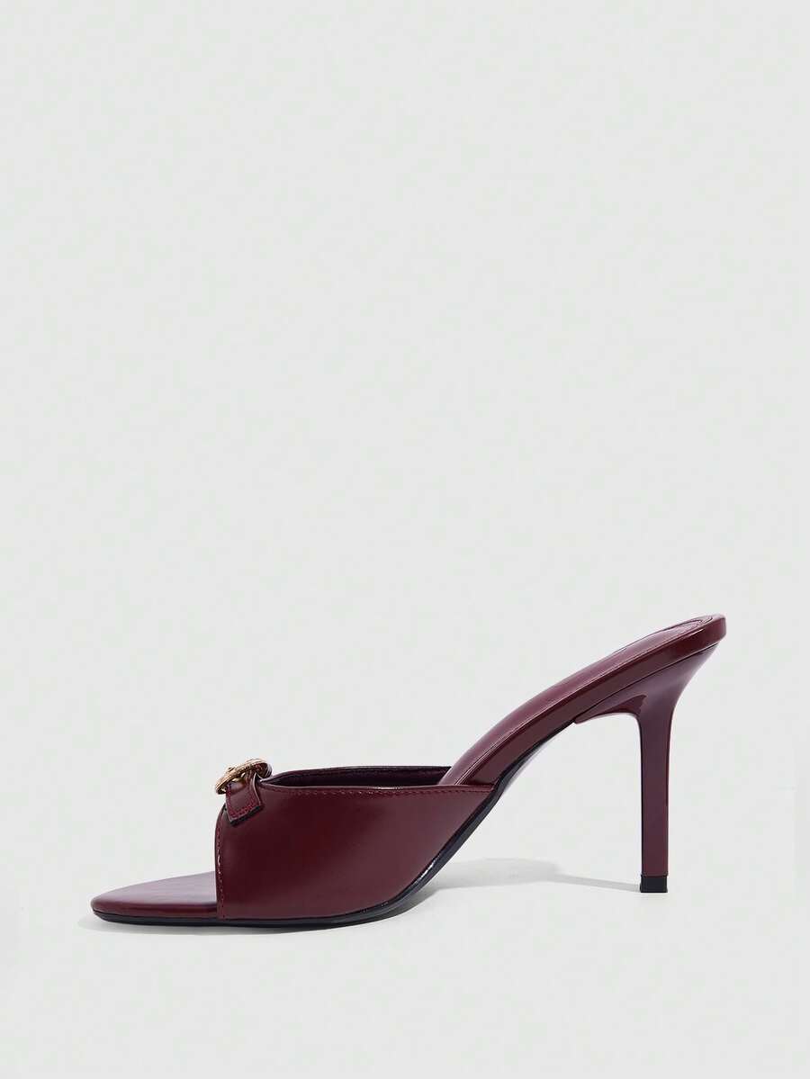 Elegant burgundy high heel slingback sandals with an open toe and round buckle strap.