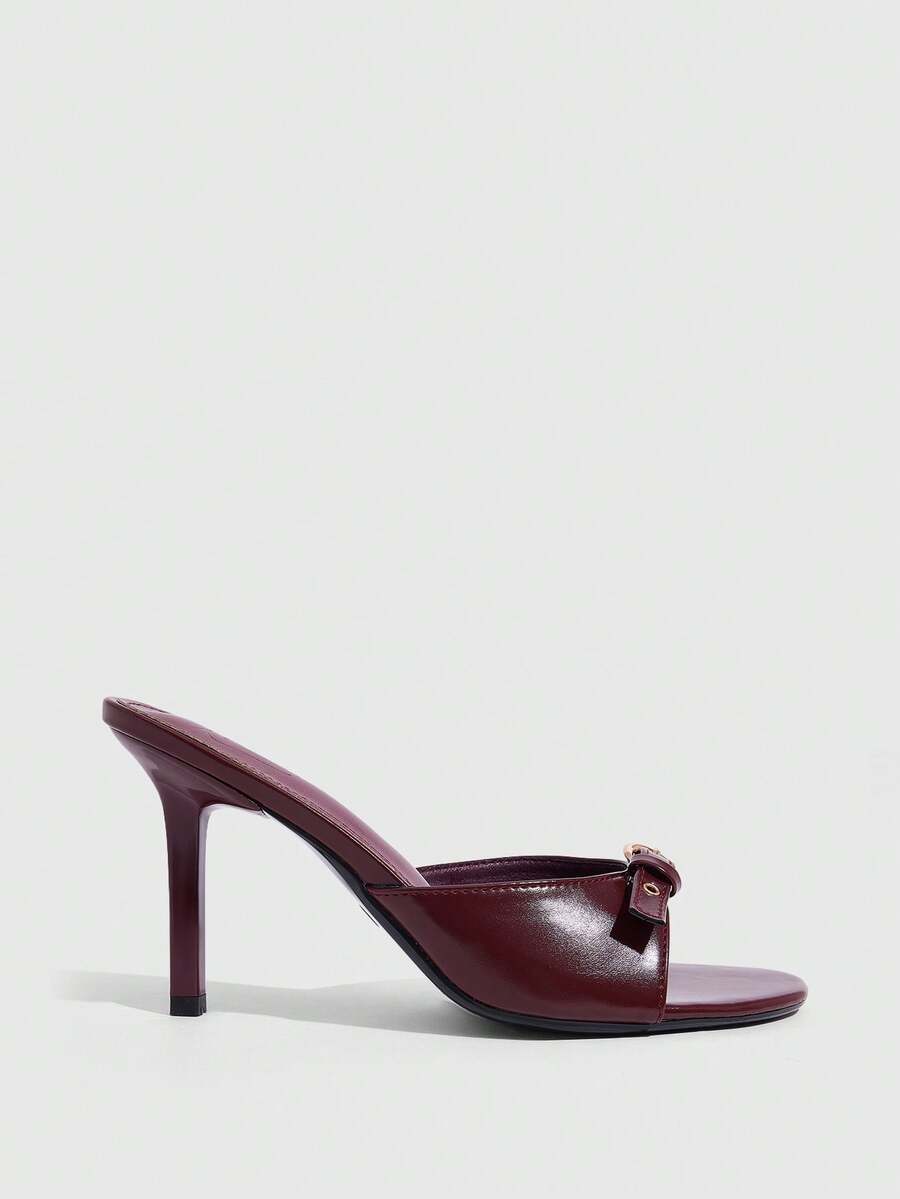 Elegant burgundy high heel slingback sandals with an open toe and round buckle strap.