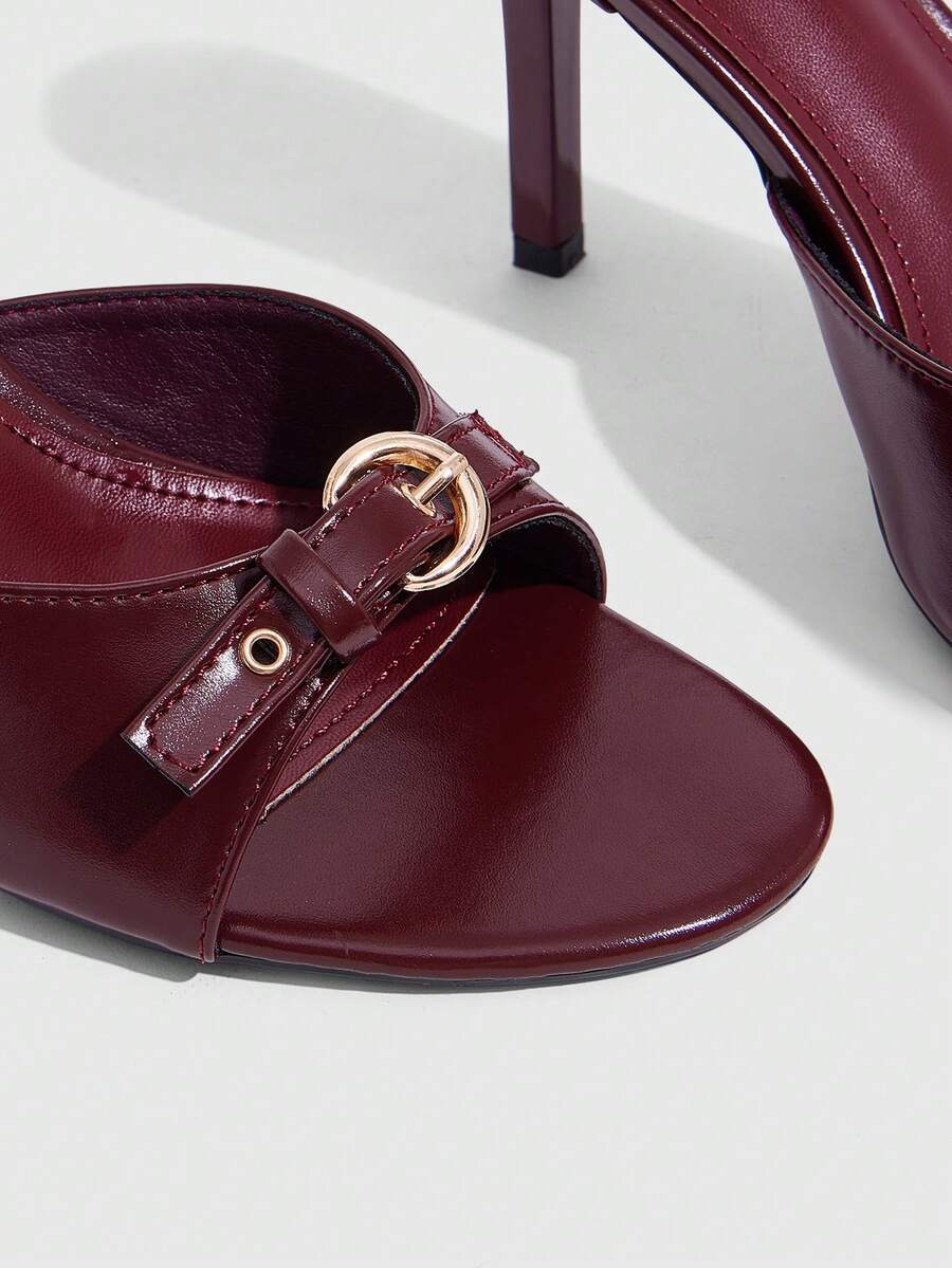 Elegant burgundy high heel slingback sandals with an open toe and round buckle strap.